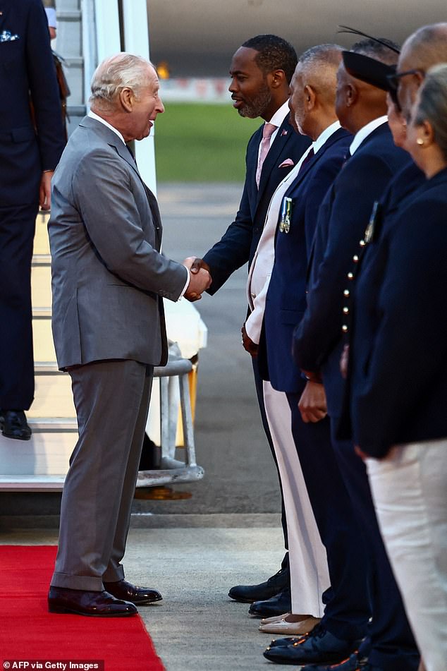 King Charles is greeted by Bermuda's Premier David Burt upon his arrival to the L.F. Wade International Airport in Hamilton