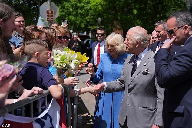 Charles and Camilla greet local people from the town