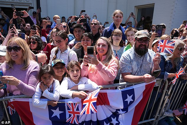 People wait for Britain's King Charles III and Queen Camilla during a parade in Front Royal