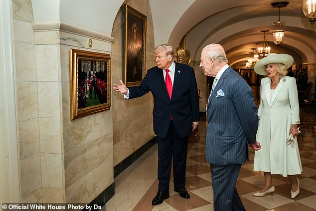 President Trump points out a particular image to the King and Queen inside the White House