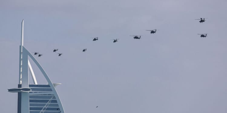 United Arab Emirates army helicopters fly past Burj al Arab hotel in Dubai on Jan. 16, 2026.