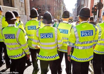 In an unprecedented crackdown, Britain's biggest force secretly unleashed an AI tool to root out bad behaviour. Pictured: Metropolitan Police officers on duty (file photo)