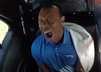 Tiger Woods pictured yawning in the back of a police car after his arrest for driving under the influence last month