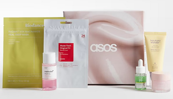 ASOS Korean beauty box containing a Biodance mask, Medicube toner, Cosrx patches, Haruharu Wonder cream, and two other items.