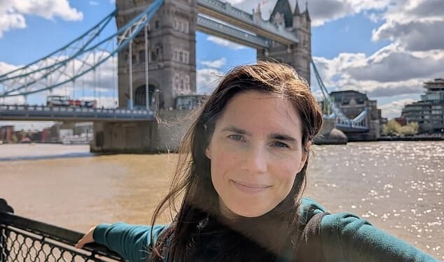 Amanda Knox, 38, smiles as she poses near Tower Bridge just miles from tragic Meredith’s family home