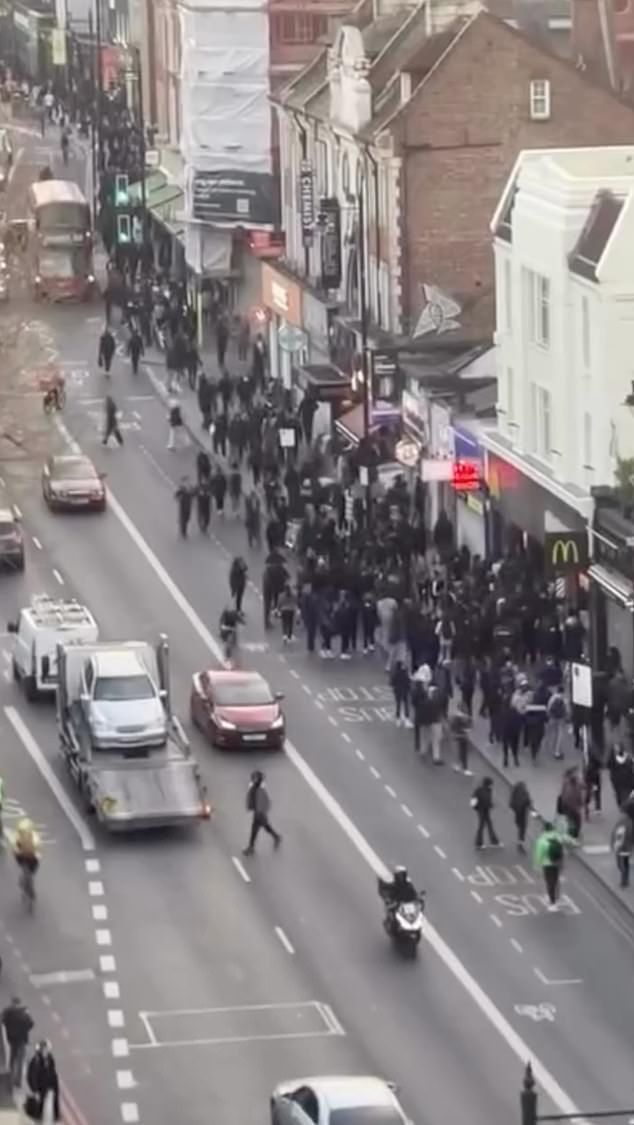 The blunder came on the same evening as a large-scale riot (pictured) on the borough's high street, which was swarmed by an enormous gang of feral youths