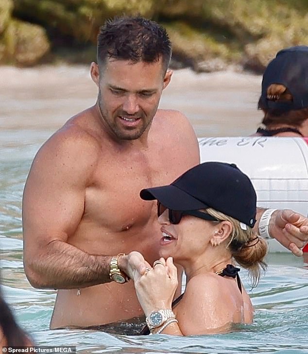 Vogue and Spencer, who wed in 2018, shared a sweet kiss as they topped up their tans while hitting the beach