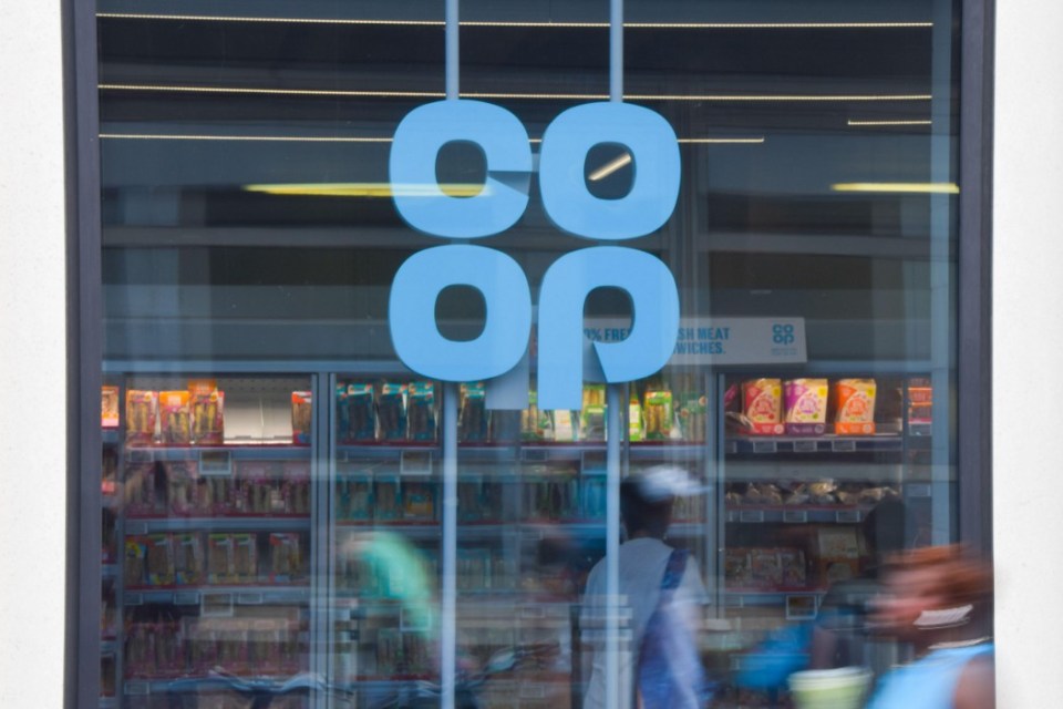 The light blue Co-op logo on the window of a Co-op store.