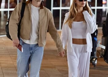 Brookes Nader stepped out hand-in-hand with Taron Egerton as they touched down in Australia on Saturday after sparking romance rumors