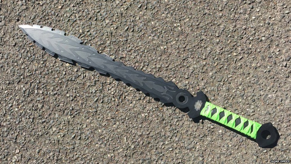 Zombie knife with a serrated blade and green wrapped handle.