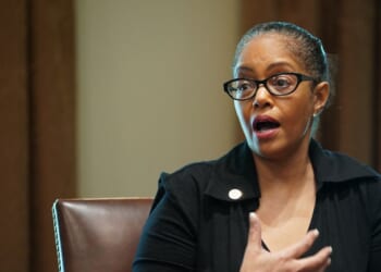 Rep. Karen Whitsett speaks as President Donald Trump, Vice President Mike Pence, and members of the Coronavirus Task Force listen during a meeting with patients in the Cabinet Room of the White House in Washington, D.C., on April 14, 2020.