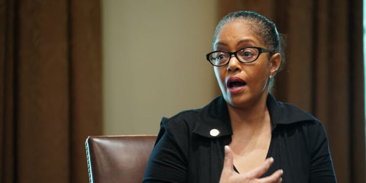 Rep. Karen Whitsett speaks as President Donald Trump, Vice President Mike Pence, and members of the Coronavirus Task Force listen during a meeting with patients in the Cabinet Room of the White House in Washington, D.C., on April 14, 2020.