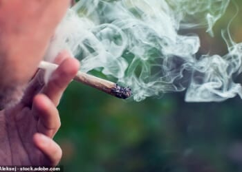 Drug offences rocketed by 18 per cent last year. Pictured: a man smokes a cannabis joint