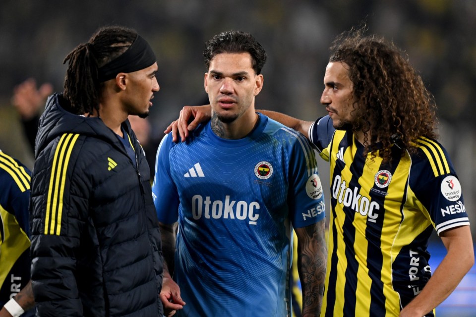 Three soccer players on the field during the Fenerbahce v Besiktas Turkish Super Lig match.
