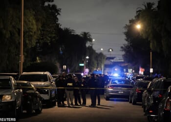 FBI agents and police officers work outside the residence associated with Cole Tomas Allen