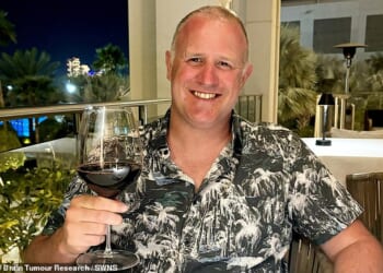 Gavin Whit (pictured), 46, was away with family in July 2023 when he suffered a seizure on the beach and was given six to 14 months to live