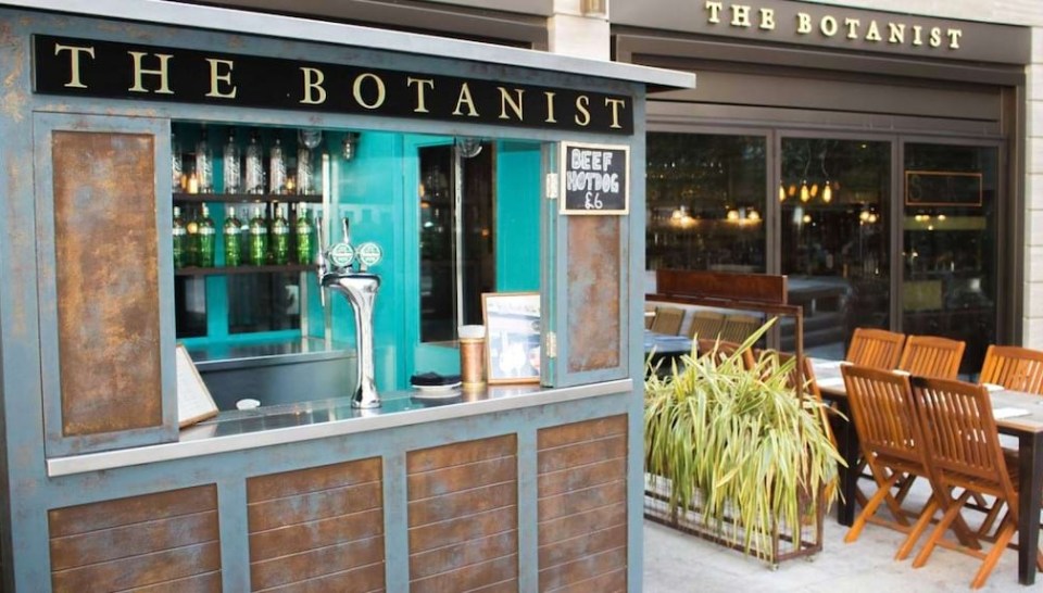 The Botanist restaurant in Bath, with an outdoor bar and tables.