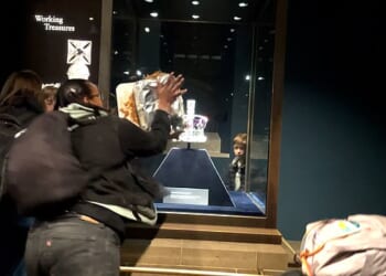 Activists smothered apple crumble and custard over a glass case containing the Crown Jewels inside the Tower of London