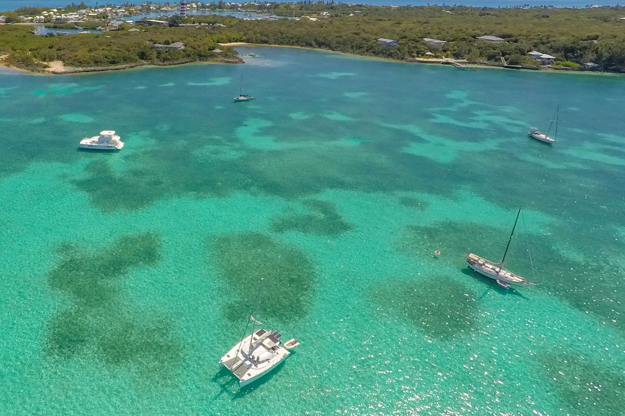 An image collage containing 1 images, Image 1 shows Yachts and Sailboats Anchored at Hope Town Lighthouse