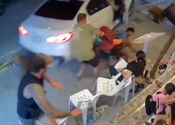 An Australian father and son were hospitalised after a car reversed over them in Thailand