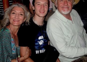 Finbar Sullivan, centre, with his mother Leah Seresin and father Christopher Sullivan, who went to the scene as soon as he heard his son had been caught up in the violence