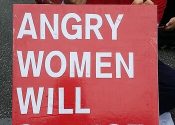 A South Korean woman in Seoul holding a placard which reads: "Angry women will change the world". South Korea has some of the most stark gender inequalities of any developed country