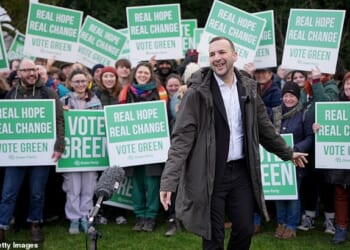 The Greens were on Sunday accused of choosing local election candidates who boast of 'compassion' despite openly promoting 'abhorrent' anti-Semitic conspiracy theories Pictured: Green Party leader Zack Polanski attended a campaign event at Gorton and Denton in February