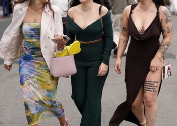 Here come the girls! Glamorous Aintree racegoers don daring frocks and jumpsuits to kick off the Grand National festival in style