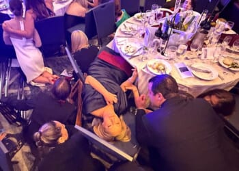 Several gunshots rang out as panicked attendees immediately ducked under their tables to protect themselves. A few journalists stayed seated or knelt, filming the chaos
