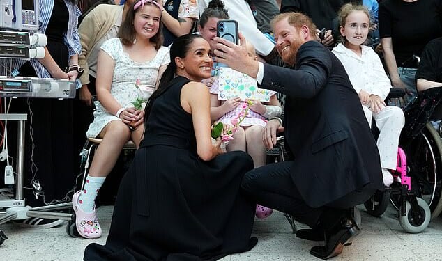 The Duke and Duchess of Sussex were feted for visiting a hospital in Melbourne, posing with young patients yesterday