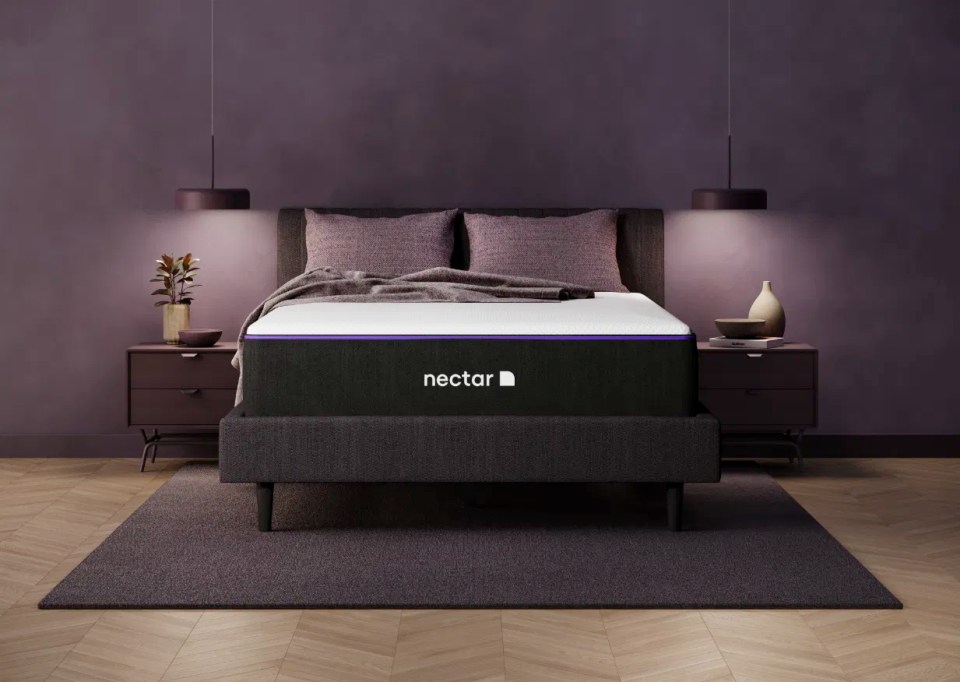 Nectar mattress on a bed frame in a purple-themed bedroom.
