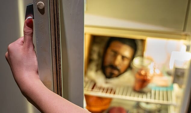 A man's head sits on a shelf in the refrigerator inside the re, a man’s head stares back from a shelf inside
