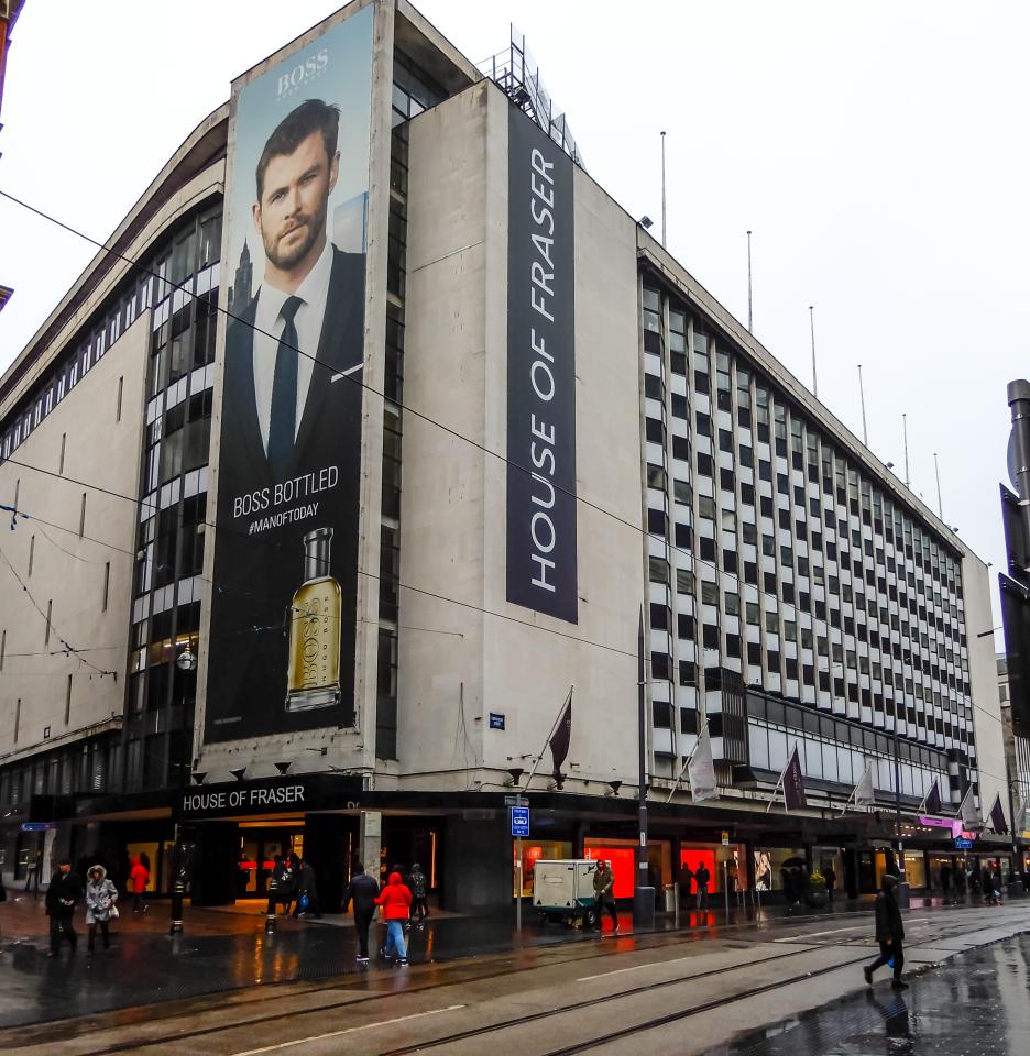 House of Fraser building in Birmingham, with a large "Boss Bottled" billboard featuring Chris Hemsworth on its side.