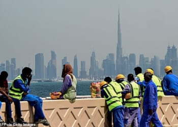 While influencers cry about their dogs, some labourers face death as they are forced to continue working in areas under attack (Pictured: Migrant workers in Dubai on March 11)