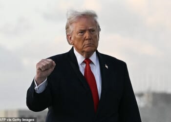 US President Donald Trump makes a fist upon arrival at Miami International Airport in Miami, on April 11, 2026. Trump is traveling to Florida to attend a UFC event and spend the weekend at his Mar-a-Lago residence