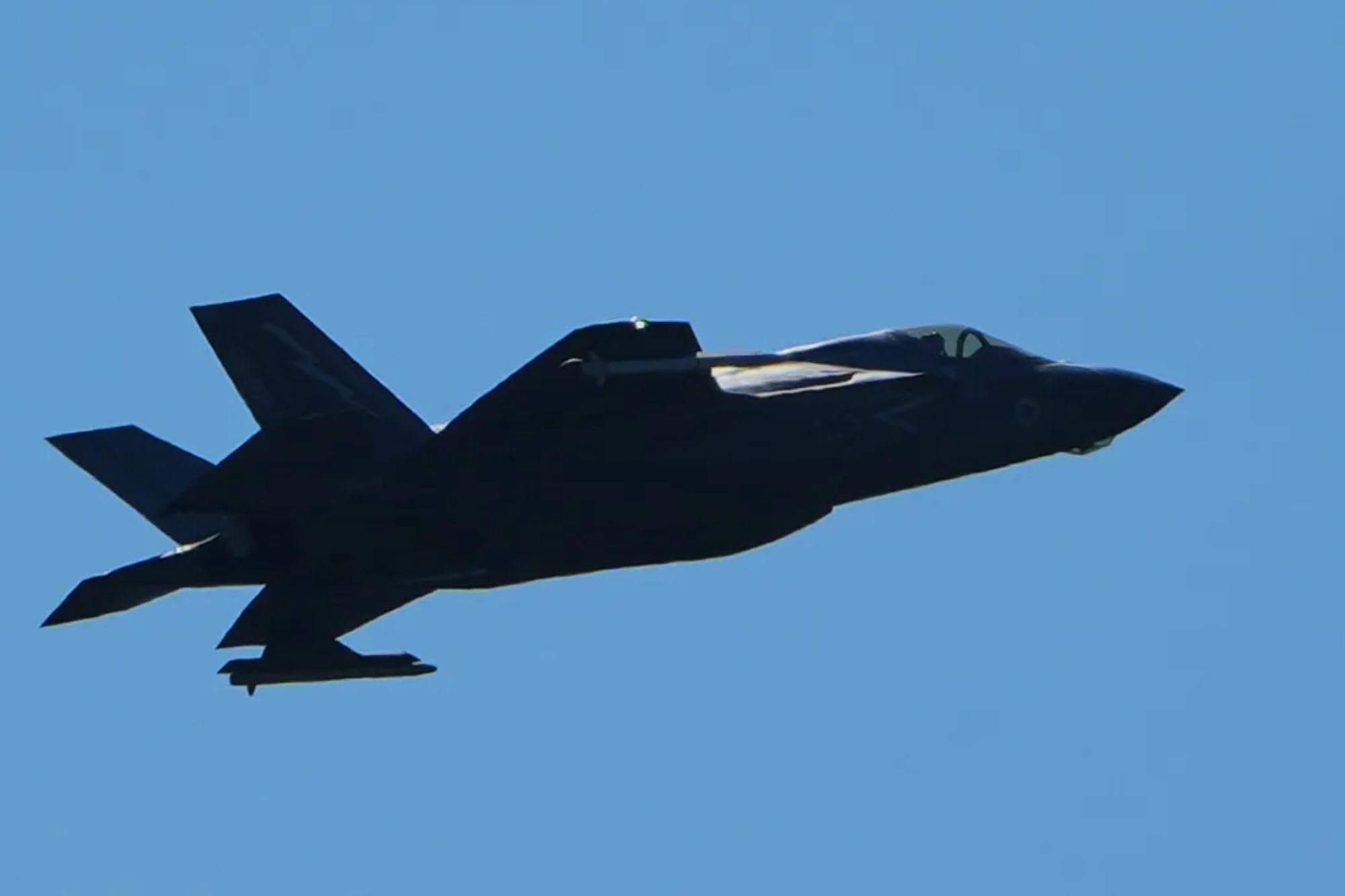 An image collage containing 1 images, Image 1 shows A fighter jet in flight against a clear blue sky