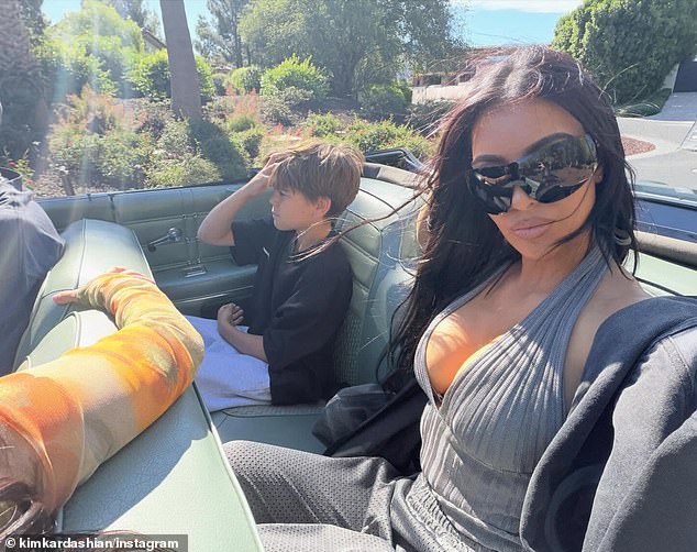She also posted a selfie of her casual-chic outfit as she sat in the backseat beside her nephew, Kourtney's son Reign