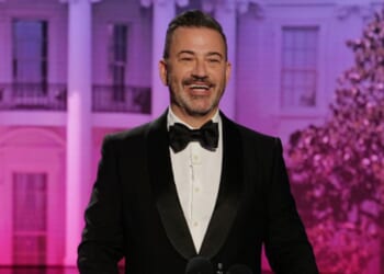 Jimmy Kimmel laughs at podium as he makes jokes to his crowd in a parody of the WHCD on April 23, 2026.