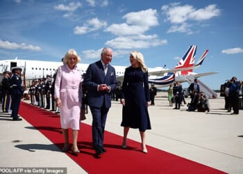 King Charles III and Britain's Queen Camilla are greeted by US Protocol Chief Monica Crowley as they arrive at Joint Base Andrews