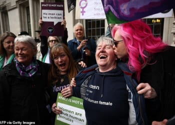 The Supreme Court judgment specified that ¿woman¿ in the Equality Act referred to biological sex, but a Daily Mail audit has found that NHS trusts, police forces, town halls and Whitehall departments are failing to comply. Pictured: Crowds of people cheered and broke into song after the ruling was handed down