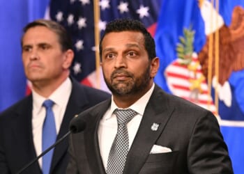 FBI Director Kash Patel stands in front of Attorney General Todd Blanche as he explains the indictment of the Southern Poverty Law Center on April 21, 2026 in at the Department of Justice in Washington, DC.