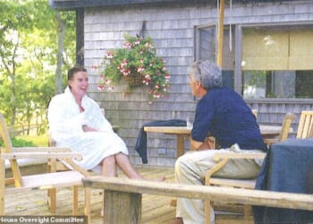 The creepy holiday snap that triggered his downfall: Lord Mandelson in a fluffy white dressing gown enjoying a chat with 'best pal' Epstein