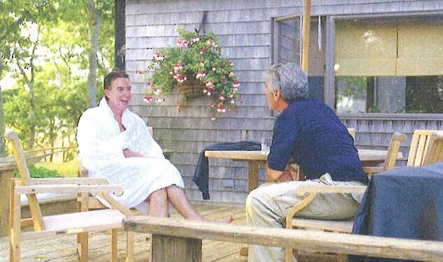 The creepy holiday snap that triggered his downfall: Lord Mandelson in a fluffy white dressing gown enjoying a chat with 'best pal' Epstein