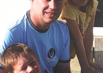 Headteacher of Stretford Grammar School Michael Mullins, 56, pictured with his son and daughter