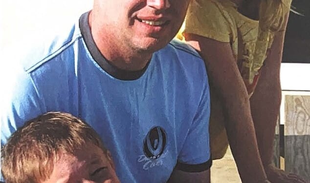 Headteacher of Stretford Grammar School Michael Mullins, 56, pictured with his son and daughter