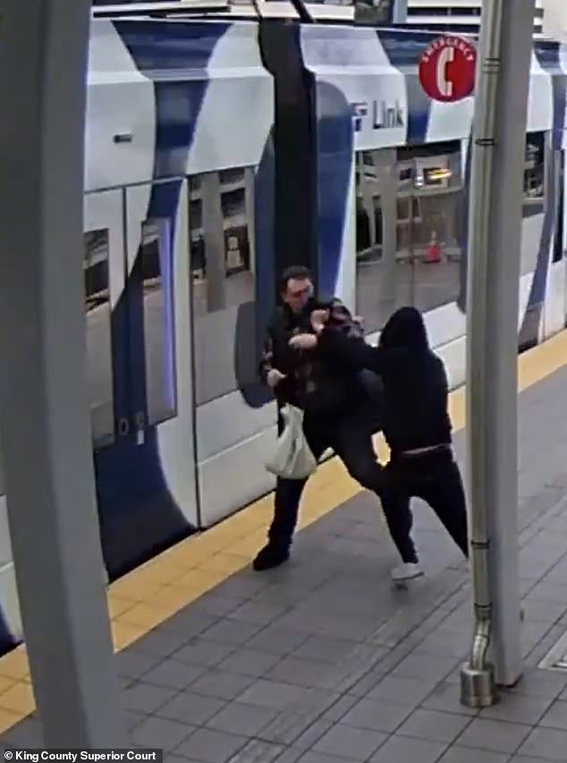 Walbrun told police he was looking at articles on his phone when he felt the violent shove, shown in surveillance footage above