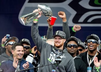 Seattle Seahawks quarterback Sam Darnold holds the Lombardi Trophy after a parade