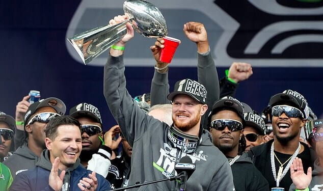 Seattle Seahawks quarterback Sam Darnold holds the Lombardi Trophy after a parade