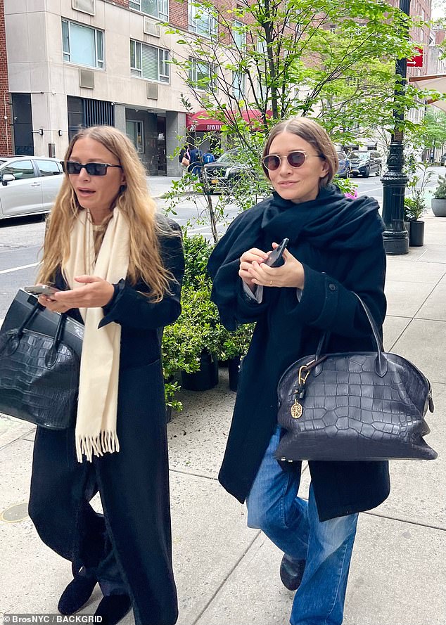 The iconic twin sisters wore matching black coats and carried similar, leather bags for their lunch date with a gal pal