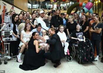 Meghan and Harry pose for a selfie with patients at the Royal Children's Hospital in Melbourne on day one of their Australian visit